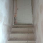 Staircase plastered to complete basement conversion