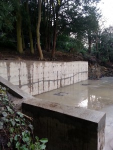 Large retaining wall holding back hillside