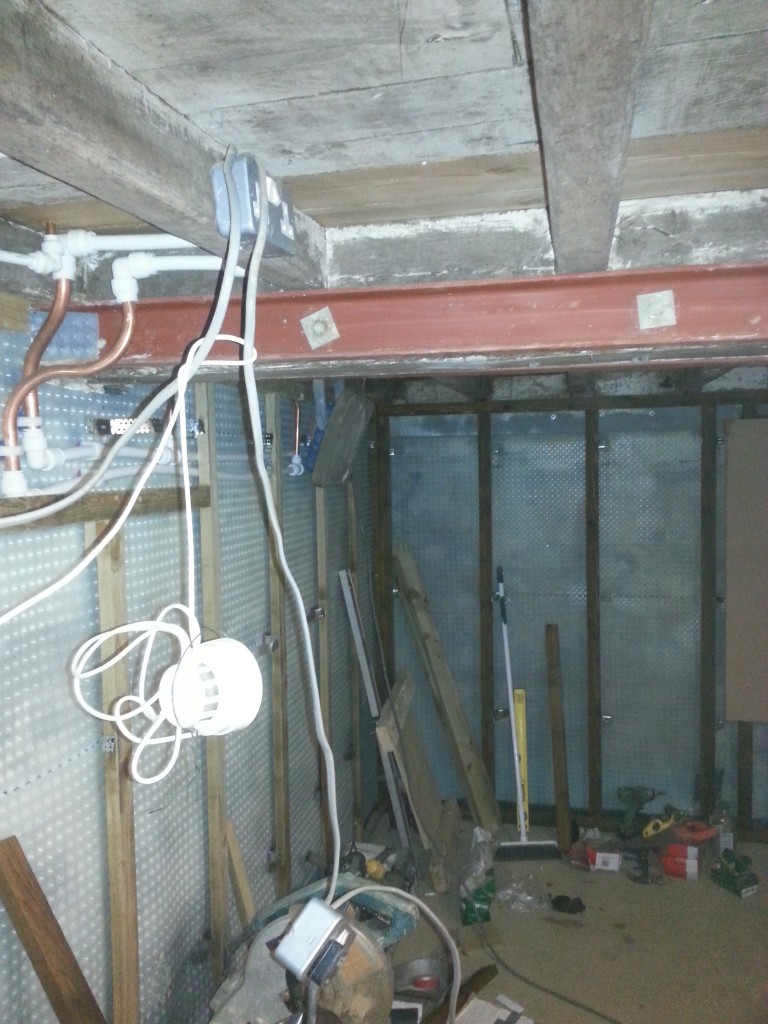 Central beam in basement braced with steel to carry floor above