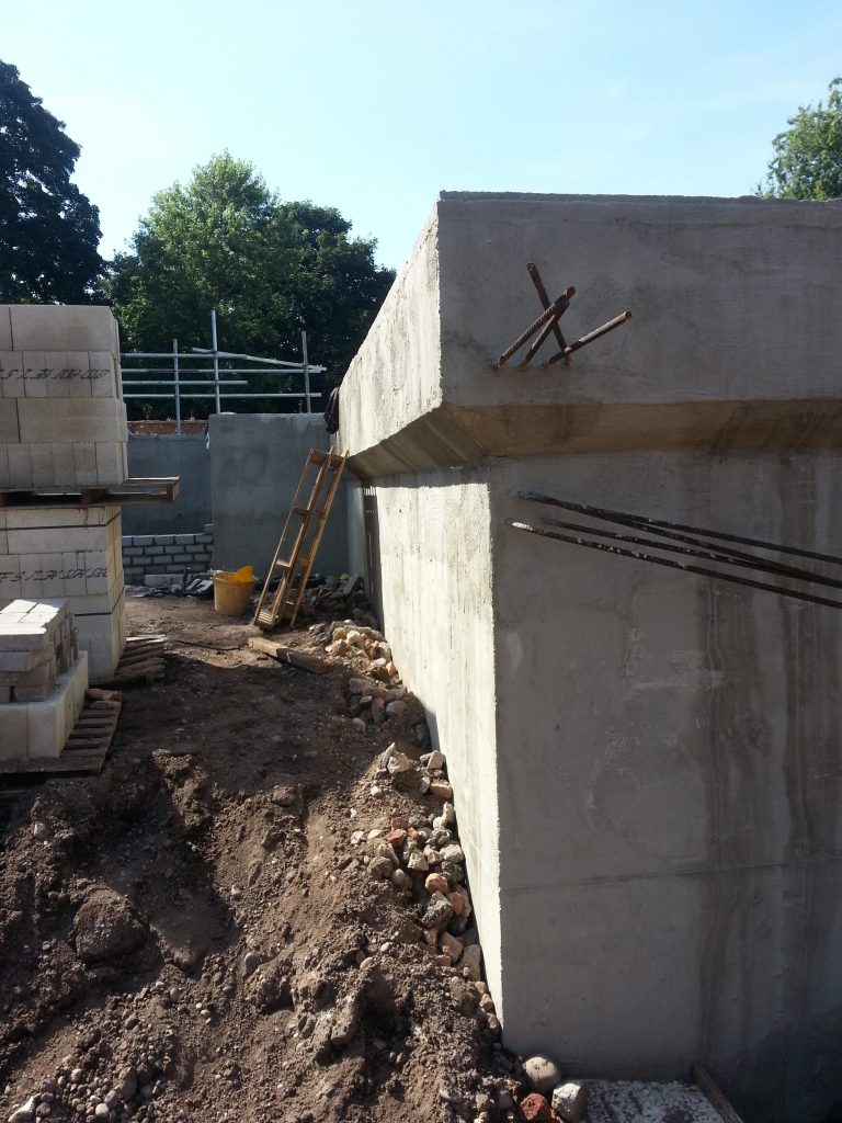 Steel reinforcing coming out of the basement walls to allow futher foundations to be joined