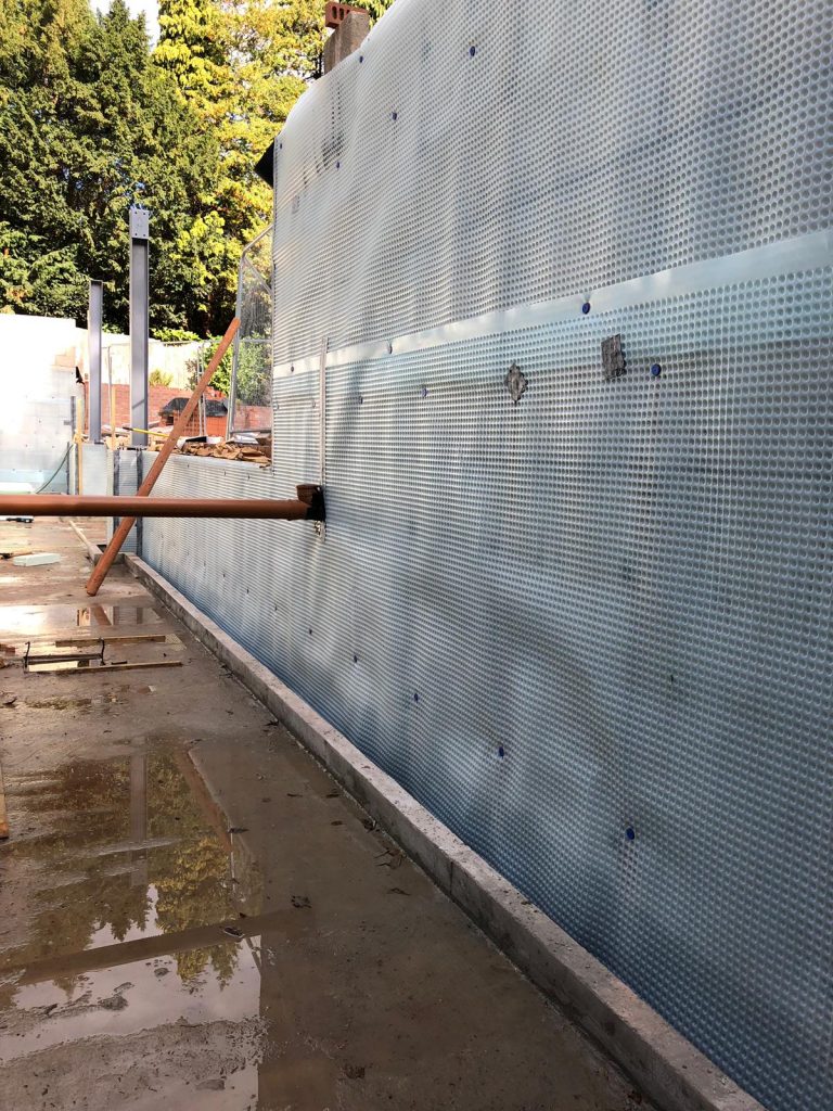 External wall membrane with seals around drainage pipe