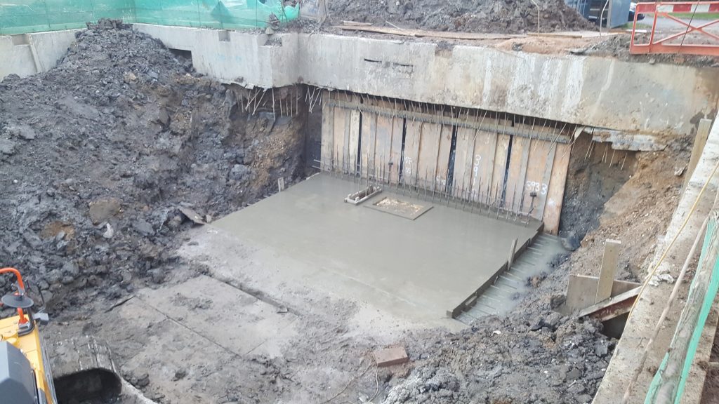 Sections of underpinning with timber boarding to prevent land slips