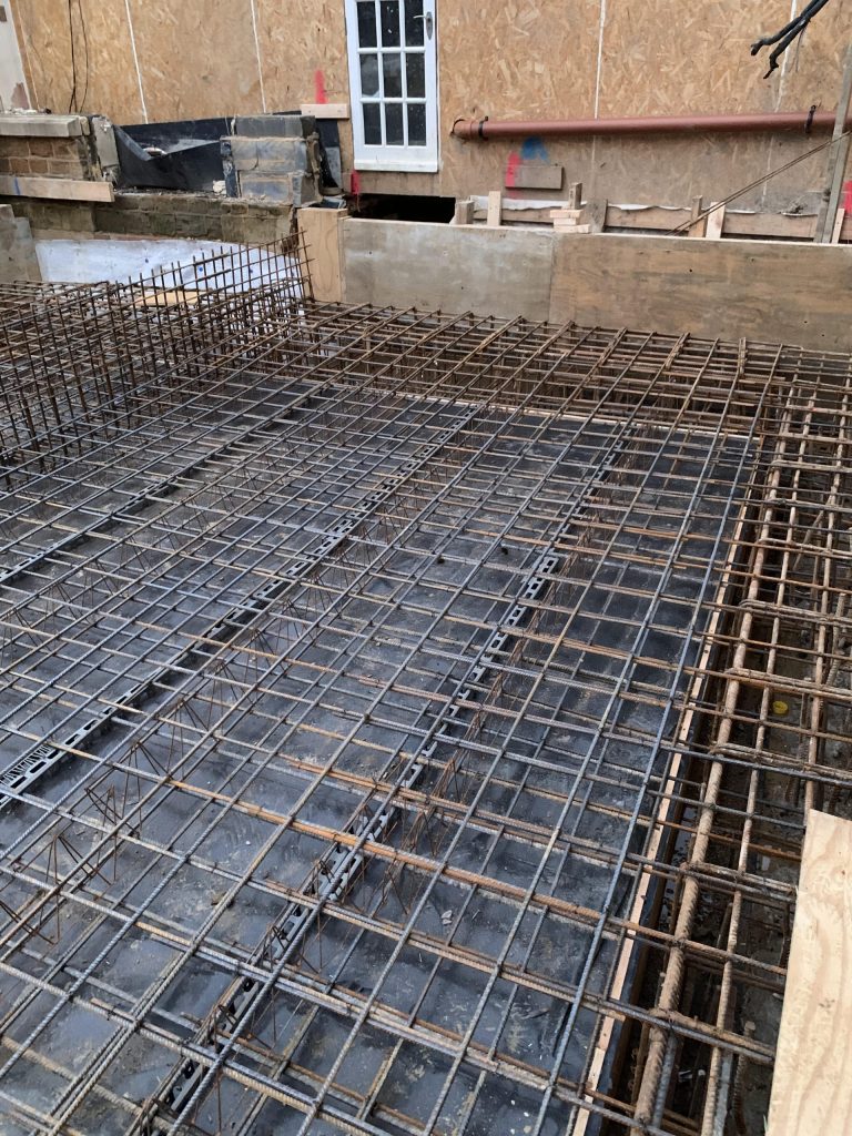 Ground floor slab reinforcing joined to pile cap beam