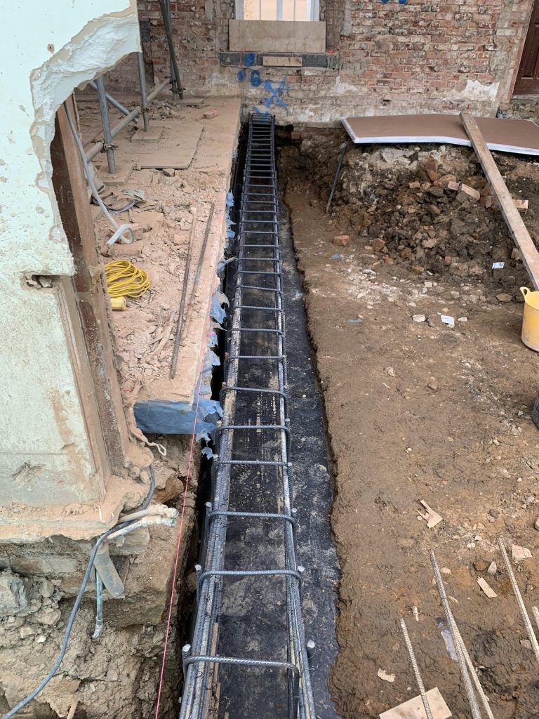 Ground beam for basement walls